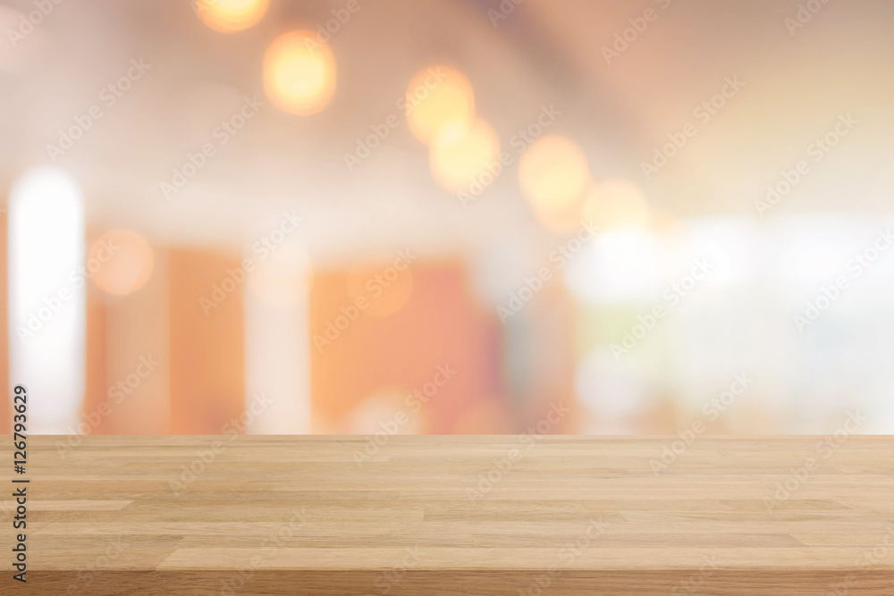Wood table top and blurred restaurant interior background with vintage filter - can used for display or montage your products. Wood table top and blurred restaurant interior background with vintage filter - can used for display or montage your products.