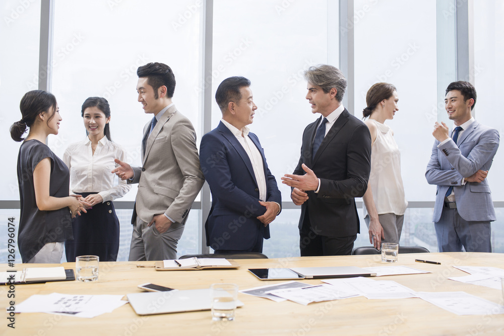 Business people talking in meeting room Business people talking in meeting room