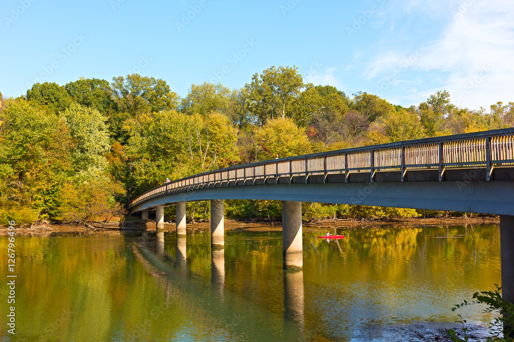 Footbridge bridge to the Theodore Roosevelt Island in Washington DC, USA. Kayaking on Potomac River in early autumn.