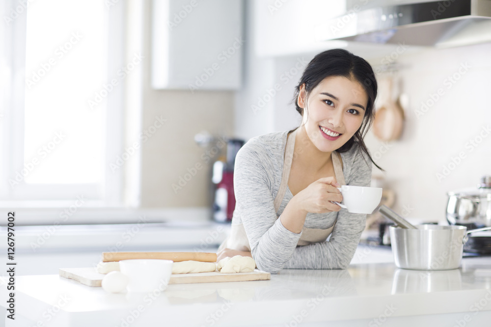 Young woman drinking coffee in kitchen Young woman drinking coffee in kitchen