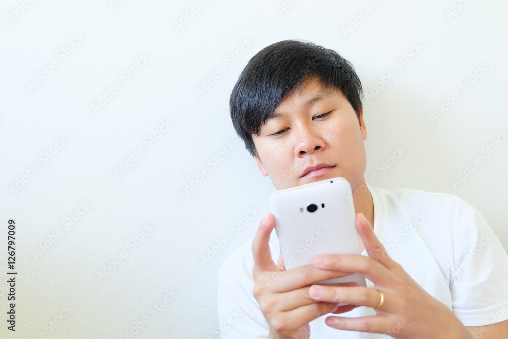 Asian human is using his smartphone on white background Asian human is using his smartphone on white background