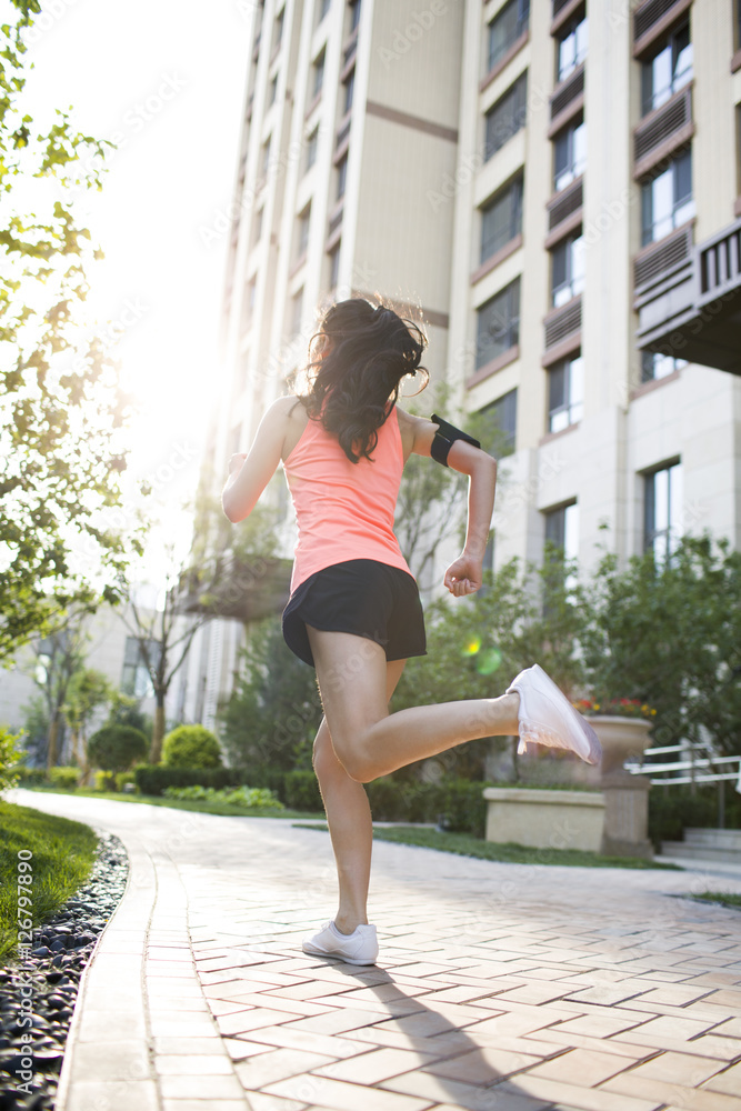 Rear view of woman exercising Rear view of woman exercising
