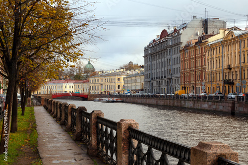 Autumn in St. Petersburg. Trees with yellow leaves on the Moika River