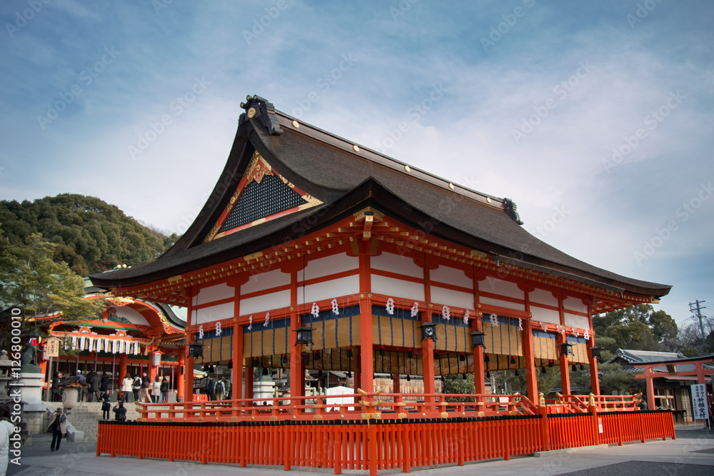 Haiden is hall of worship or oratory. Japanese traditional temple or shrine with golden red roof in Fushimi Inari shrine, Kyoto, Japan