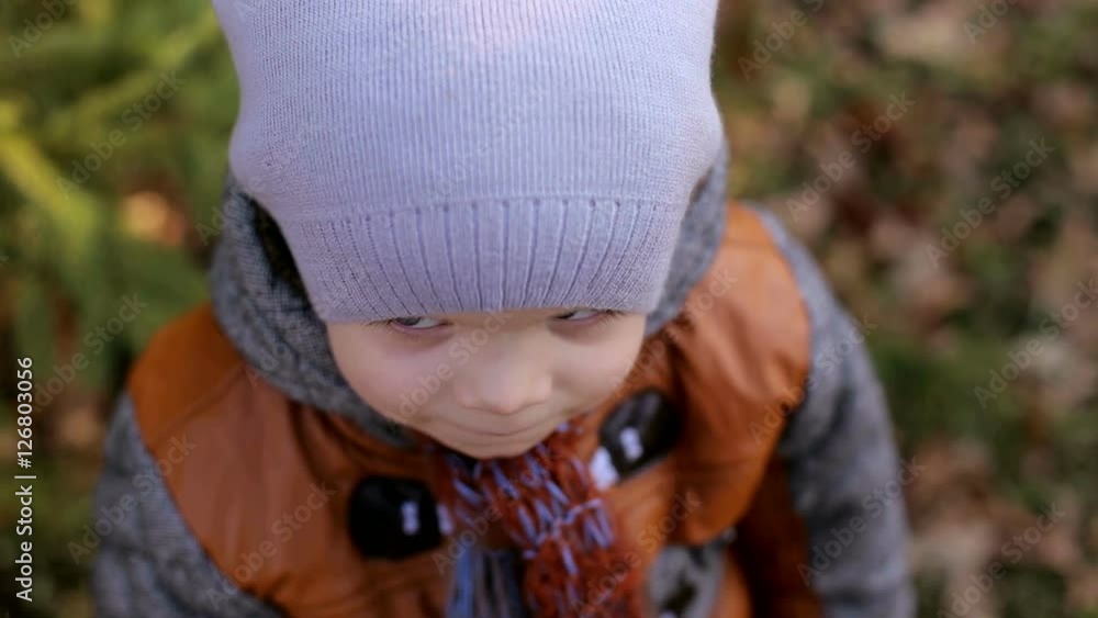 Portrait of sad young caucasian boy looking at camera. A sad little boy looks up at the camera. Portrait of sad young caucasian boy looking at camera. A sad little boy looks up at the camera.