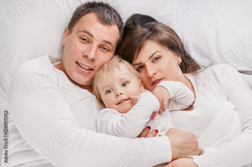 family together lying on the bed