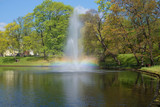 The iridescent fountain on the city channel in the sunny May afternoon. Park of the Bastionny hill, Riga. Latvia