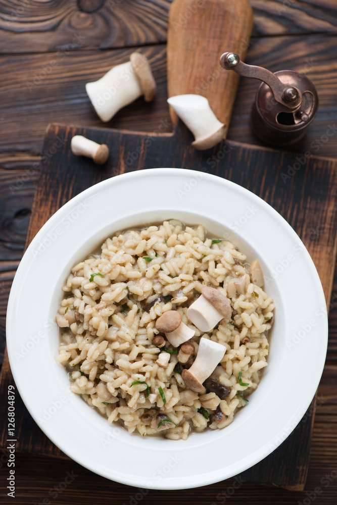 Porcini risotto served in a glass plate, view from above Porcini risotto served in a glass plate, view from above