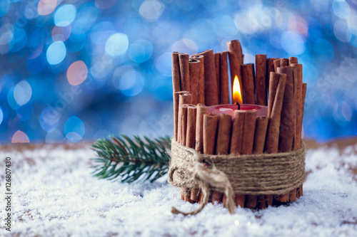 Red Cinnamon Stick Christmas Candle Burning On Snowy Wood © BestStockFoto