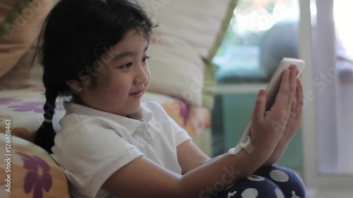 Asian girls playing a game on smart phone