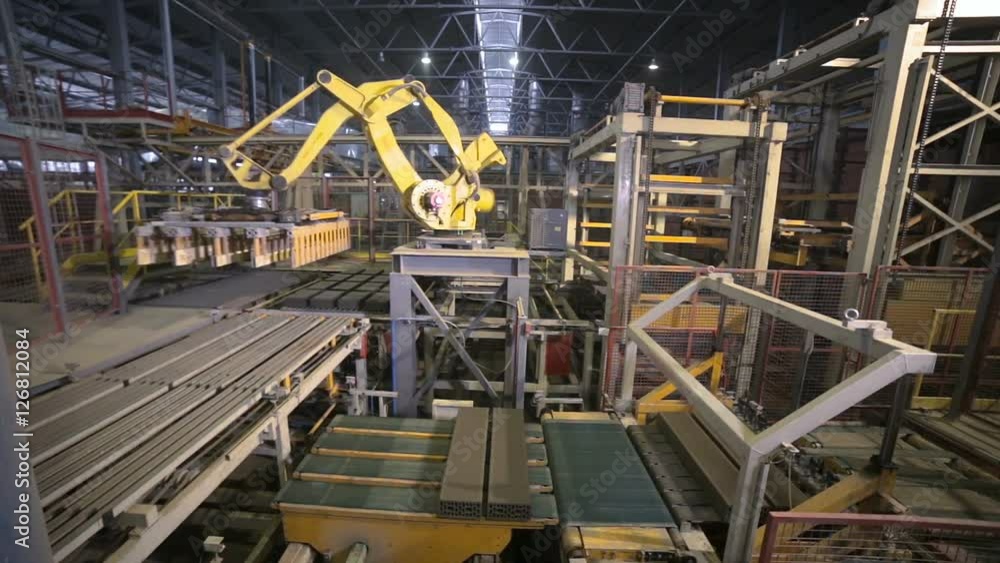 Industrial robot. Robotic arm assembling products on a modern plant. HD. Industrial robot. Robotic arm assembling products on a modern plant. HD.