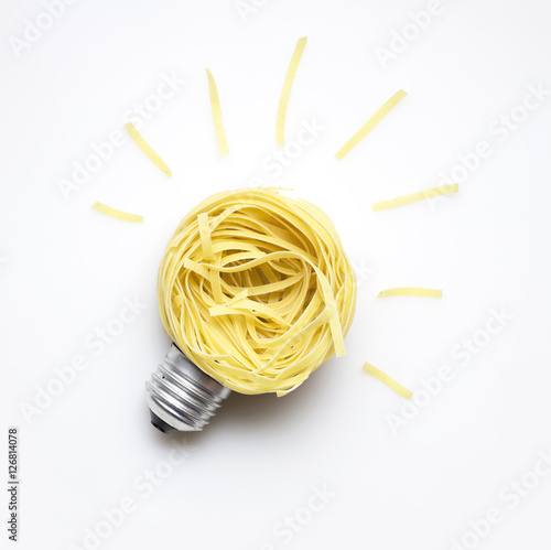 Food idea / Creative concept photo of  a bulb made of pasta on white background.