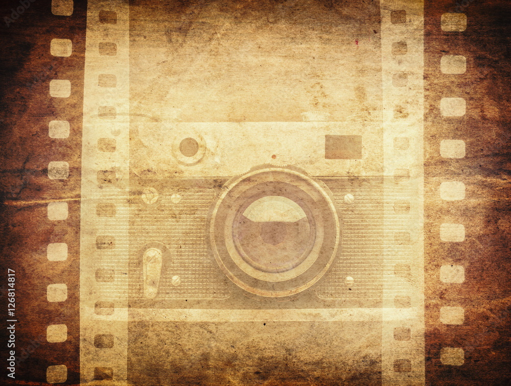 Old camera and blank film strip on vintage paper background. Stock ...