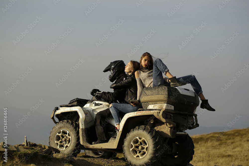 Fototapeta premium Man and girls ride quad