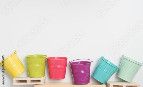 Bucket colorful and wooden board with white background