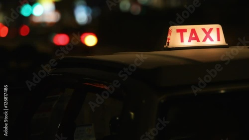 CU Passenger getting into taxi at night / Hong Kong