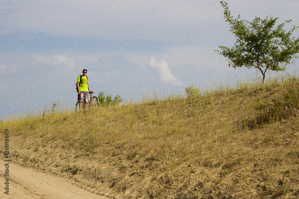 Man on the old bike is traveling across the steppe. Man on the old bike is traveling across the steppe.