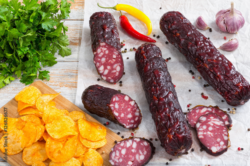 delicious Smoked sausages on white parchment paper, view from a delicious Smoked sausages on white parchment paper, view from a