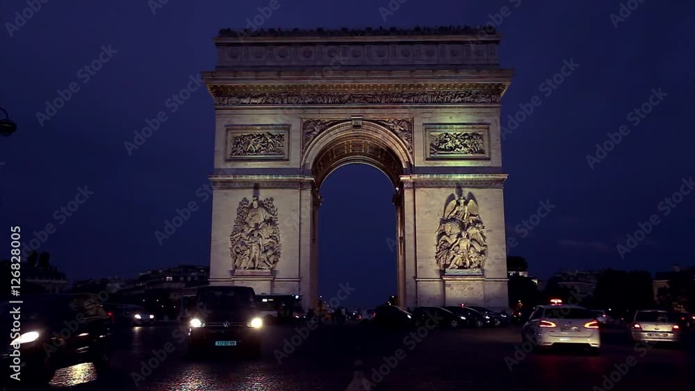 Triumphal arch. Paris. France. Static camera, real time. Place Charles de Gaulle. Famous touristic architecture landmark. Symbol of french glory. World historical heritage. Evening traffic. Toned Triumphal arch. Paris. France. Static camera, real time. Place Charles de Gaulle. Famous touristic architecture landmark. Symbol of french glory. World historical heritage. Evening traffic. Toned