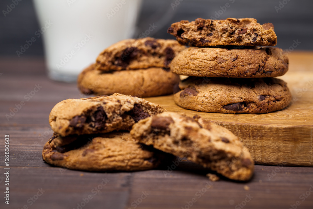 Round cookies with chocolate on a wooden table. Sweet pastries. Round cookies with chocolate on a wooden table. Sweet pastries.