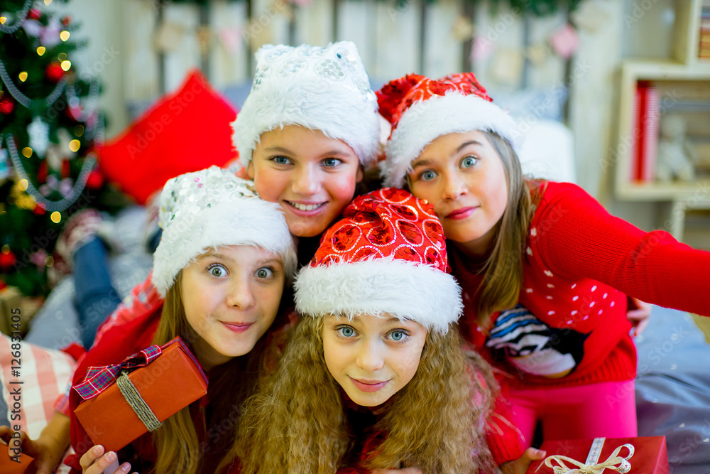 Group of kids in red hat with Christmas gifts Group of kids in red hat with Christmas gifts