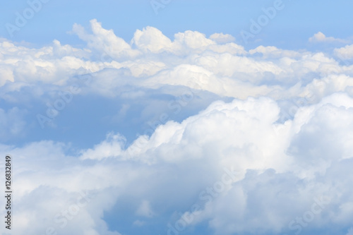 Fototapeta Naklejka Na Ścianę i Meble -  Fluffy white clouds and blue sky seen from airplane.