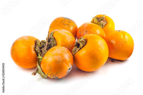 Ripe persimmon fruits isolated on a white background