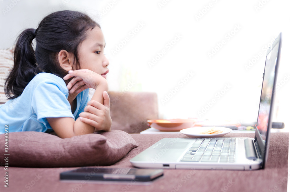 Close up portrait shot of asian little girl using laptop compute Close up portrait shot of asian little girl using laptop compute