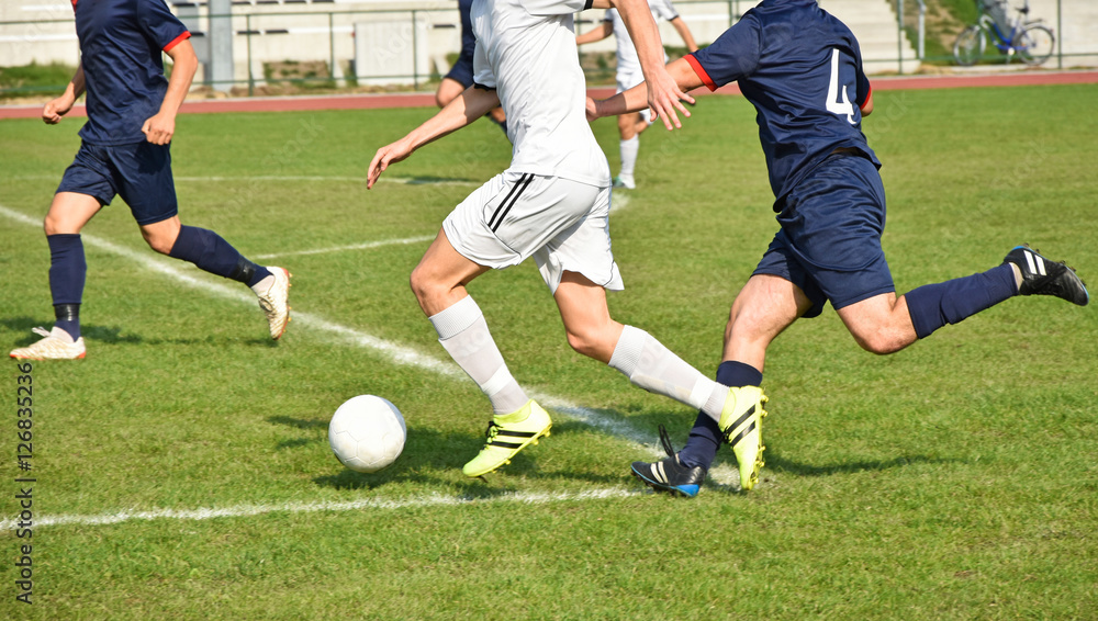 Obraz premium Running with ball at the soccer match