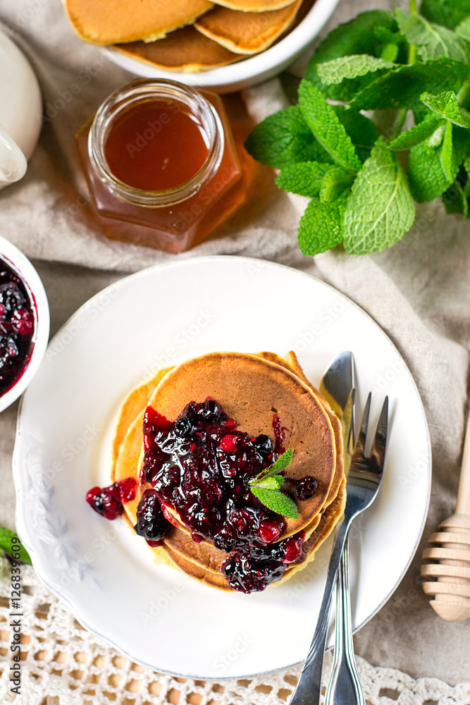 Homemade pancakes with berry sauce coulis and mint Homemade pancakes with berry sauce coulis and mint