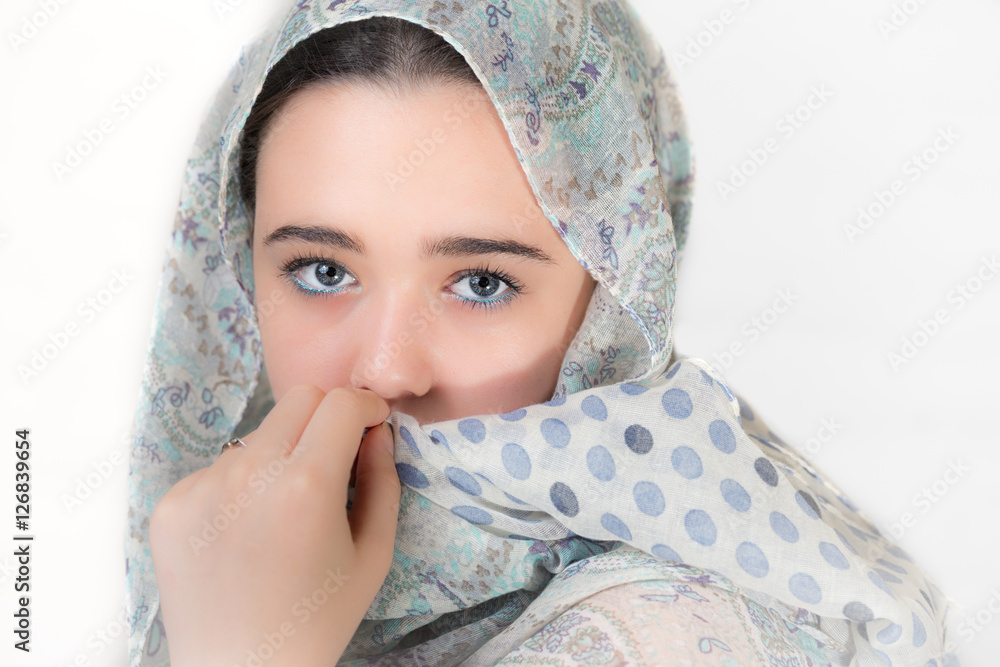 Portrait of young woman covered with a headscarf. - obrazy, fototapety, plakaty 