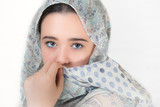 Portrait of young woman covered with a headscarf.