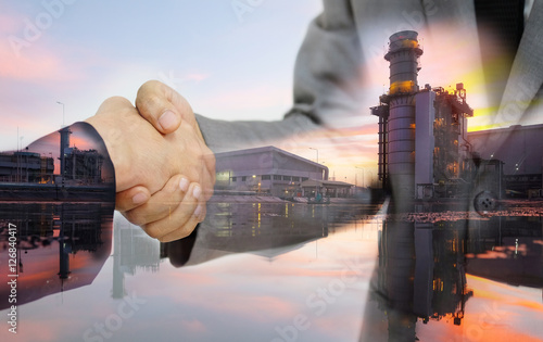 Double exposure of business women double handshake and Electric Generating Factory as Investment in energy concept.