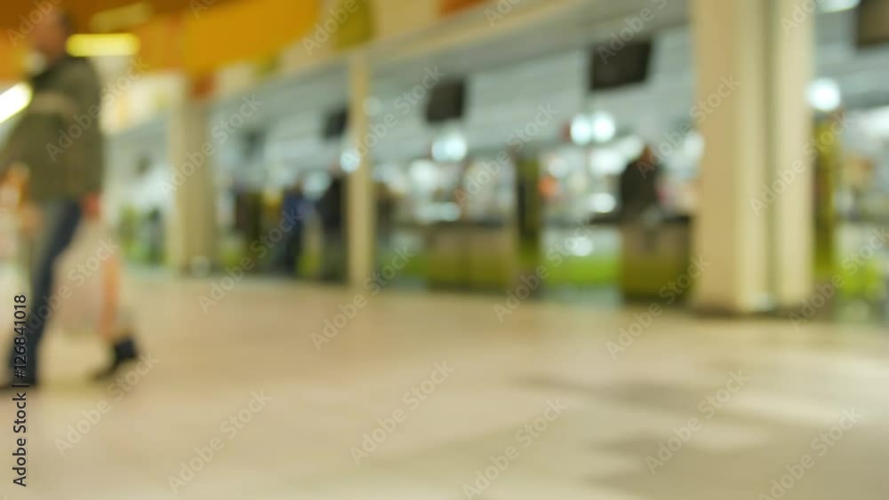 Defocused crowd in shopping mall. Defocused crowd in shopping mall.