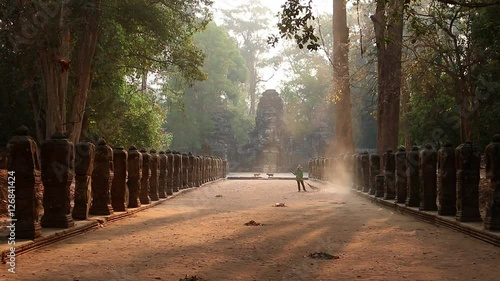 Cambodia Angkor Wat woman gives the floor a sweep