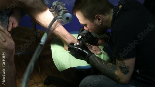 Uder lamp master makes a tattoo photo