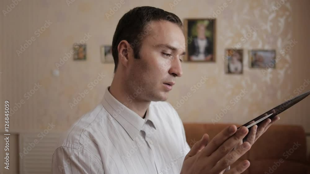 Young man gently blows away the dust from vinyl record. He snuggles the vinyl record to him. Music album refreshed affecting memoirs. Young man gently blows away the dust from vinyl record. He snuggles the vinyl record to him. Music album refreshed affecting memoirs.