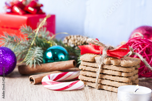 Gingerbreads with a ribbon on a wooden christmas table with a bl