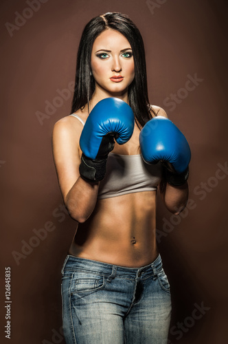 Photography Beautiful brunette woman with blue boxing gloves