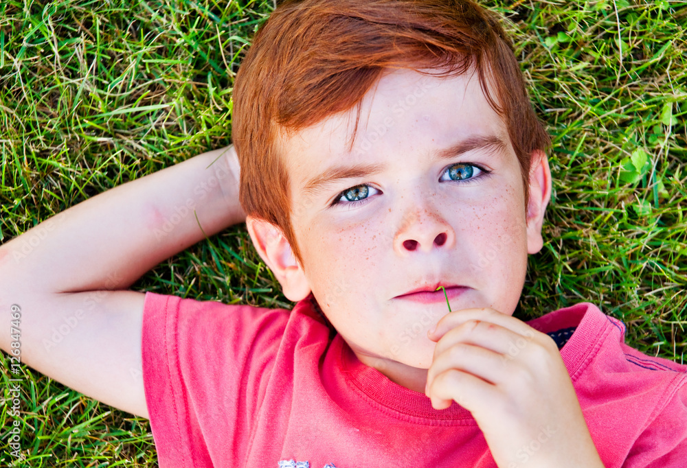 Portrait of cute lying on grass Portrait of cute lying on grass