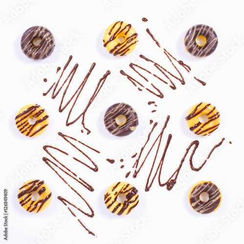 Nine Donuts on a White surface with Chocolate decoration
