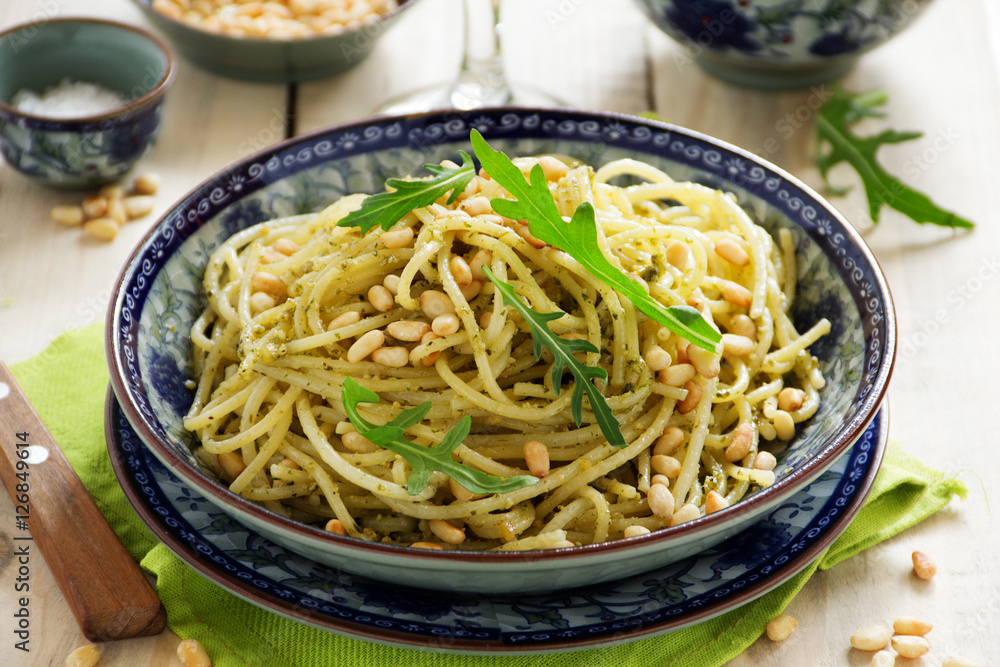 Spaghetti with pesto of arugula with pine nuts.