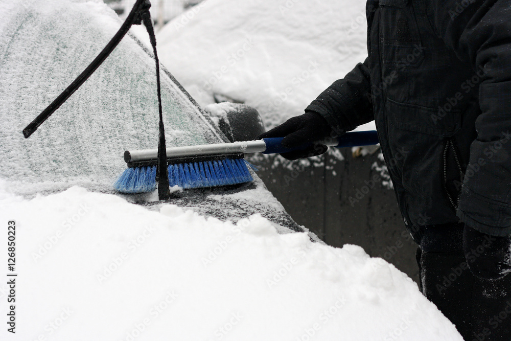 The man who cleans the car from snow. The man who cleans the car from snow.