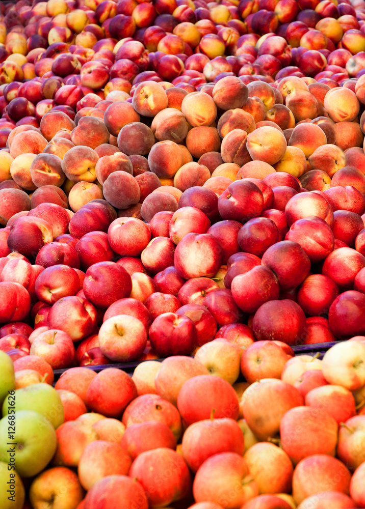 Fresh apples and peaches in a fruit shop Fresh apples and peaches in a fruit shop