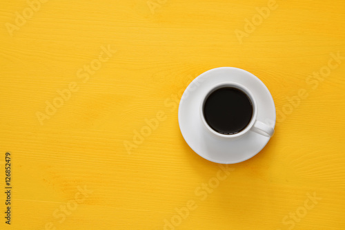 coffe cup on wooden yellow background
