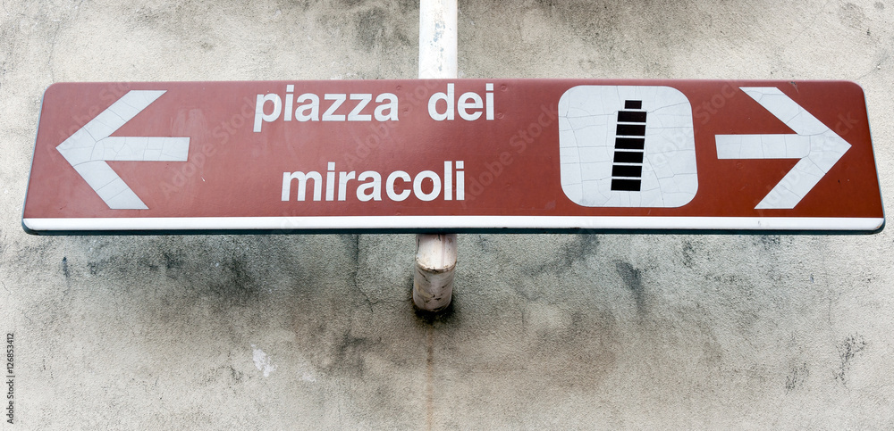 Two way directional road sign to leaning tower in Pisa, Italy