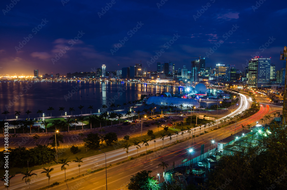 Skyline of large African city Luanda and its seaside during the blue hour with many lights