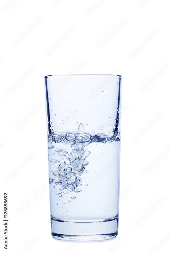 Water pouring in glass isolated on a white Water pouring in glass isolated on a white