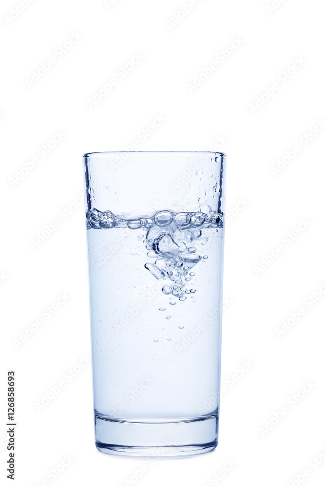 Water pouring in glass isolated on a white Water pouring in glass isolated on a white