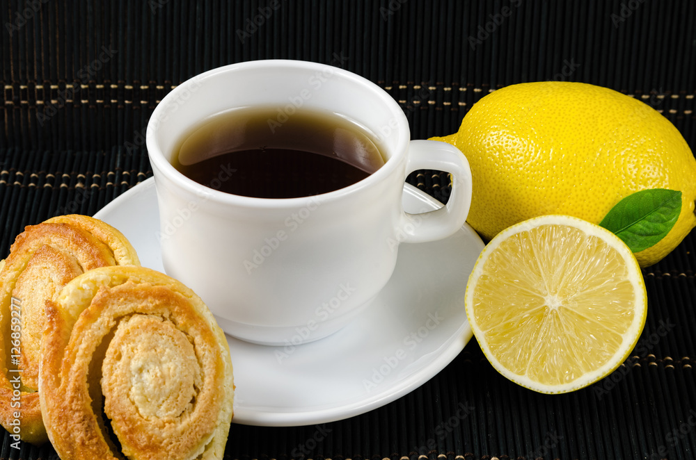 cup of hot black tea, lemon, homemade cookies cup of hot black tea, lemon, homemade cookies